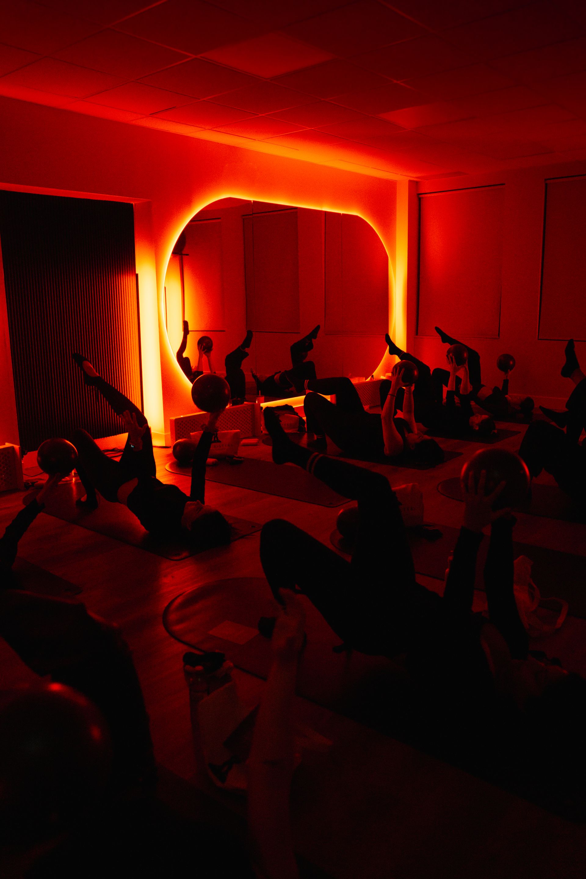 Mat Pilates class with red light therapy in Oakville